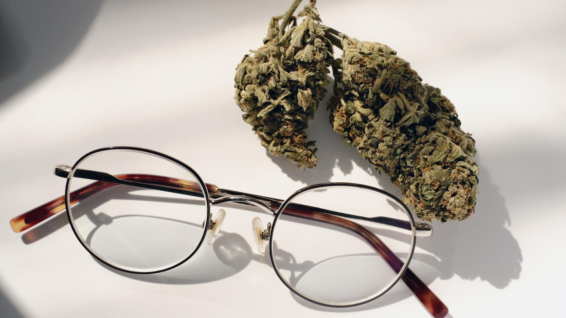 Glasses and marijuana side by side on a table.