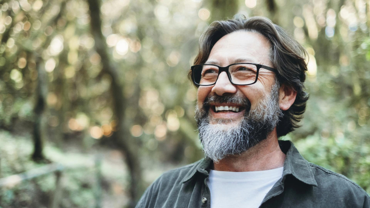 Smiling man with glasses outdoors