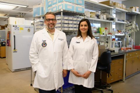 Two scientists standing side-by-side