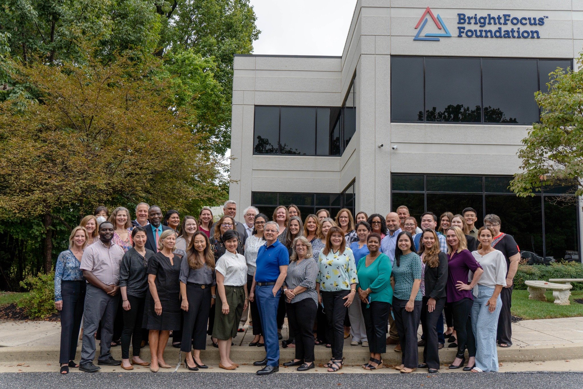 A group photo of the BrightFocus Foundation staff standing in front of their office building.