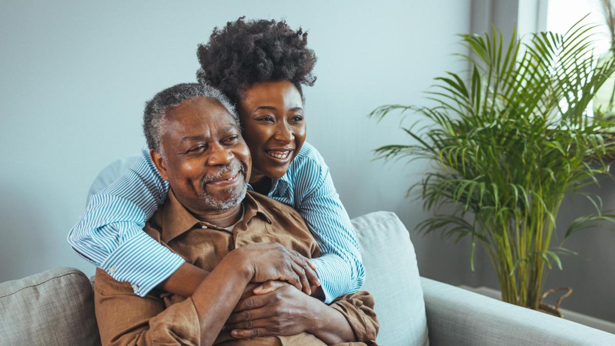 Adult daughter embracing senior father.