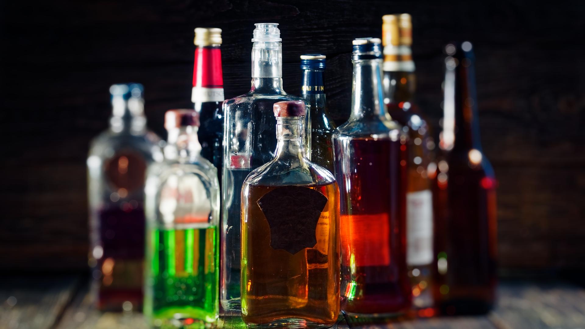 A collection of bottles of alcohol on a table.