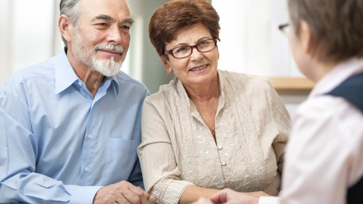 Older couple meeting with a doctor.