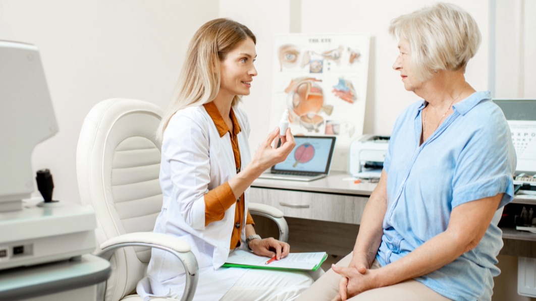 Generate by AI Assist A healthcare professional is holding a clipboard and consulting with a patient in a medical office. The room is equipped with medical technology.