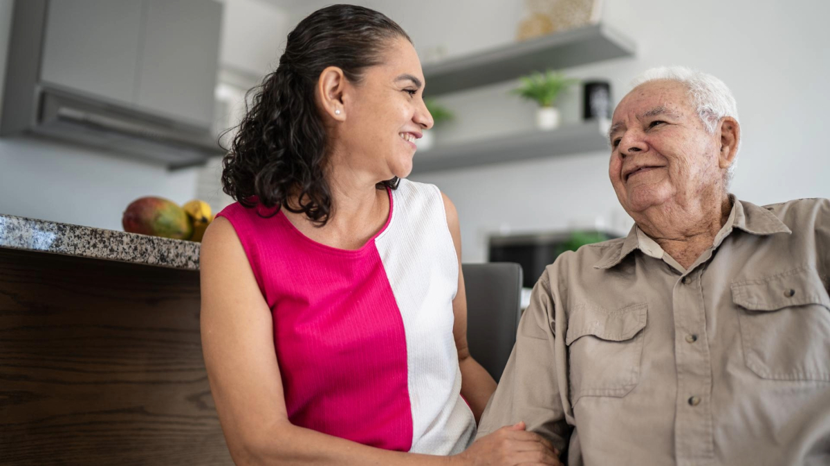 Generate by AI Assist Two adults smiling and interacting joyfully in a kitchen setting.