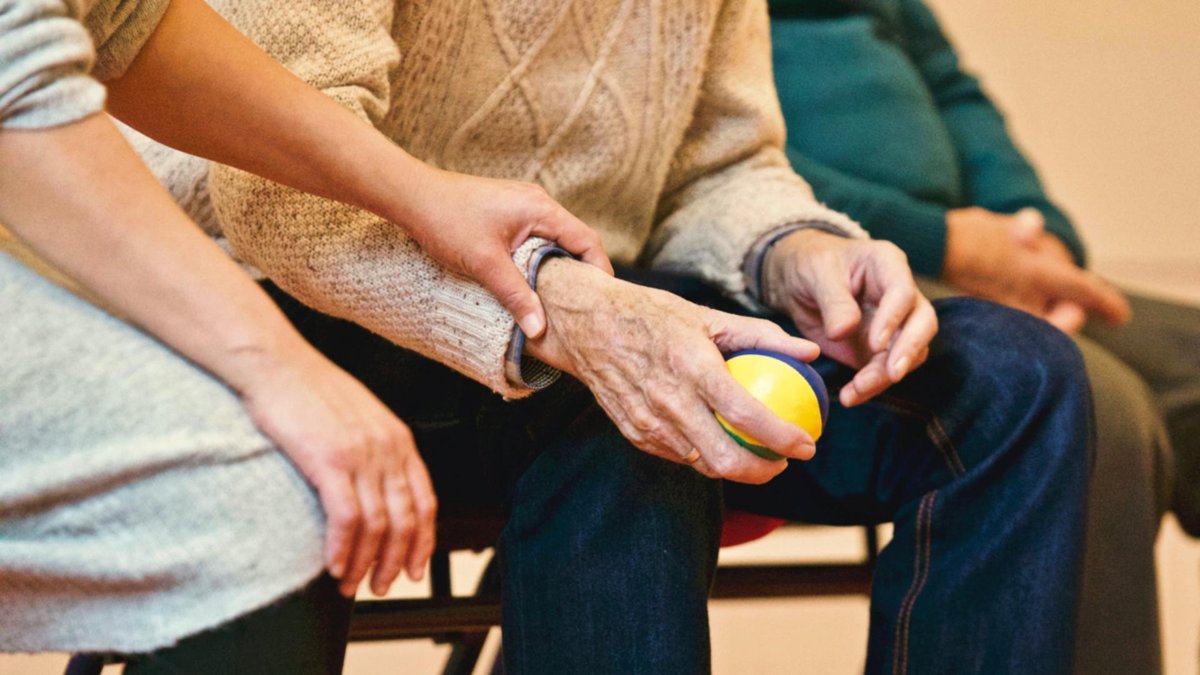 Two seniors sit beside each other.