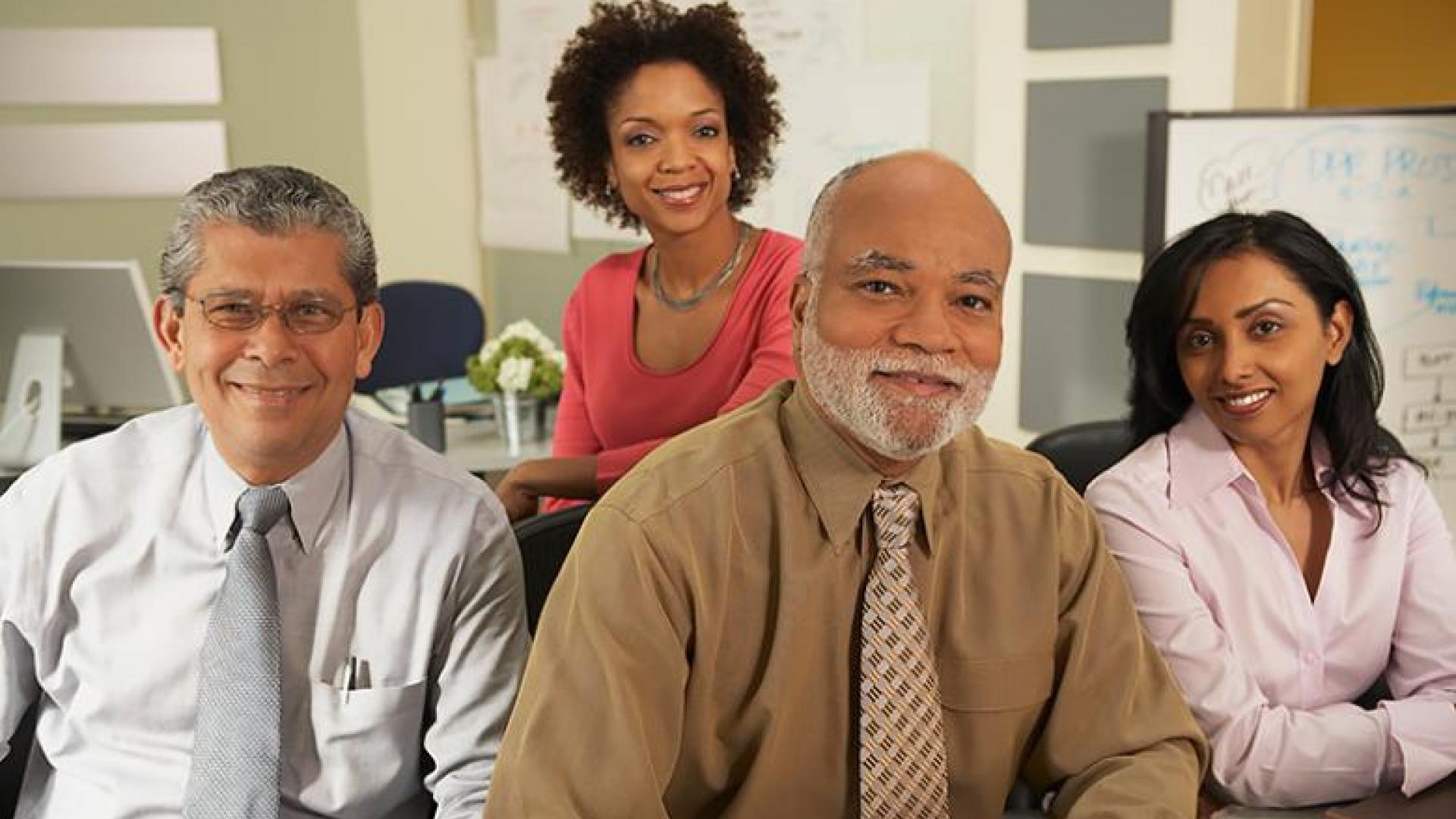 A photograph of two men and two women, all with different non-white skintones