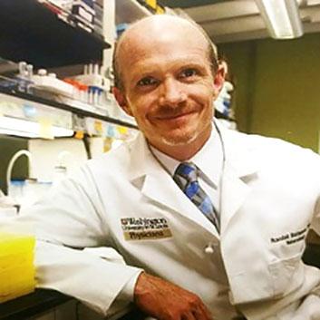 Randall Bateman, MD, sitting in his lab.