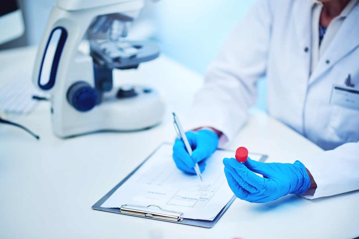 Cropped shot of a scientist recording the results of a blood test