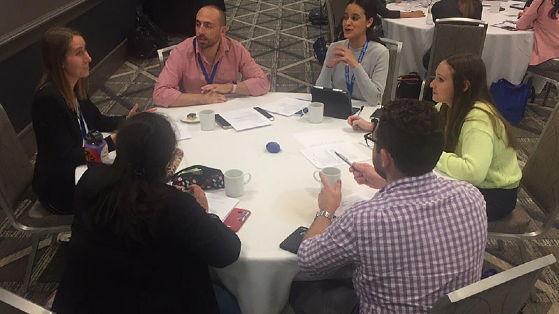 Alzheimer's Fast Track participants having a discussion while sitting a circular table.