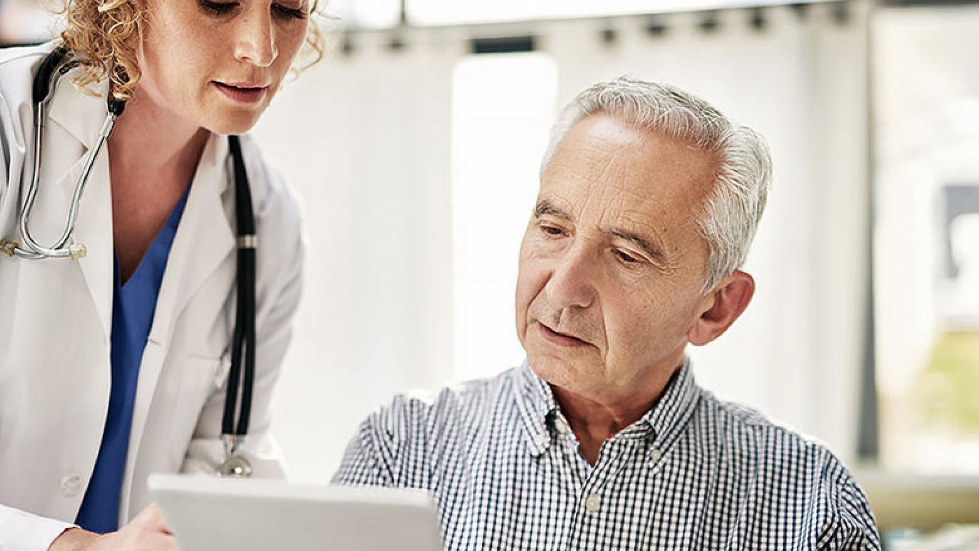 Senior man reading paperwork from doctor.