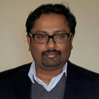 a headshot of Dr. Verghese