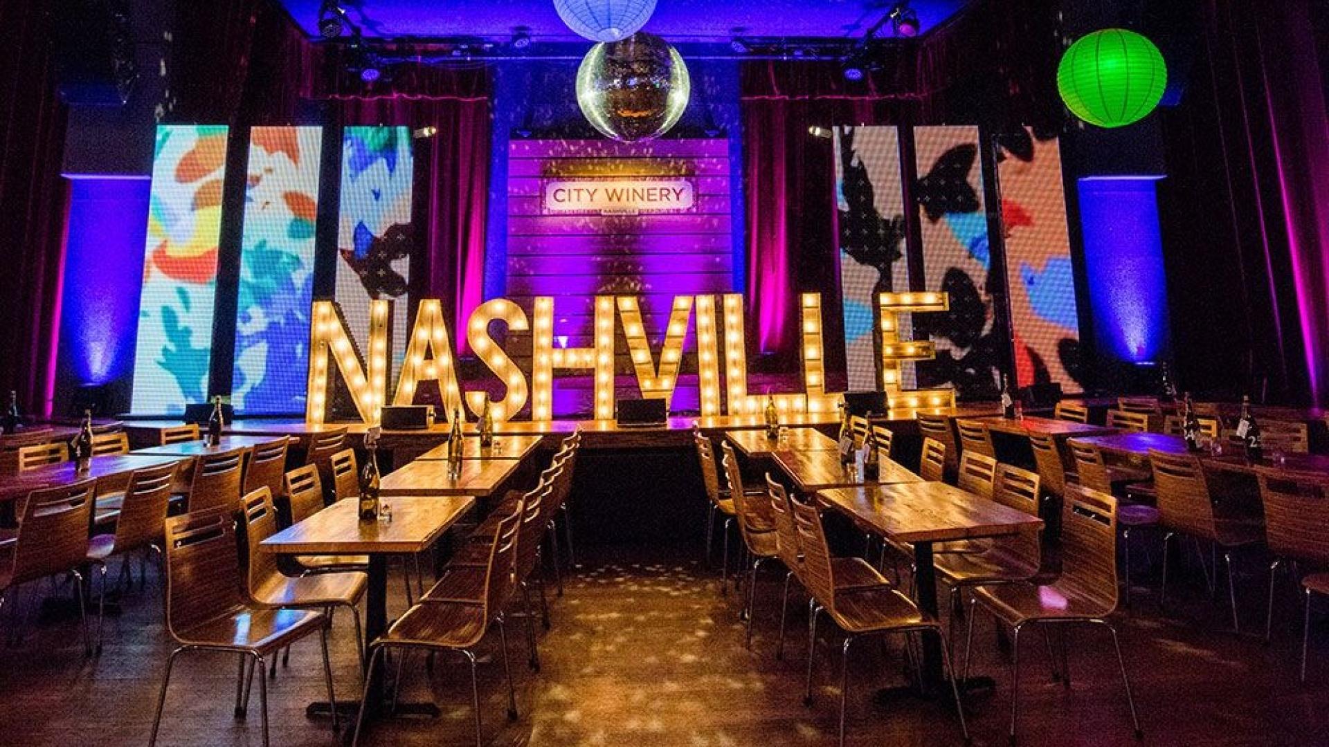 City Winery Nashville venue setup with illuminated Nashville sign and vibrant lighting.