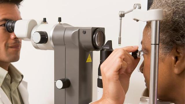 Eye doctor uses different tools to examine a woman's eyes.