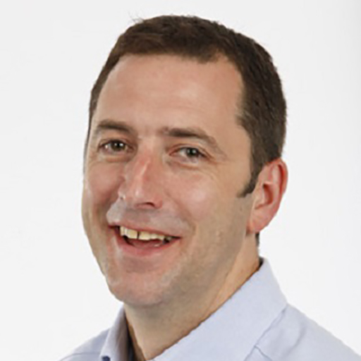 Formal portrait of Associate Professor Gareth Howell against a white background.