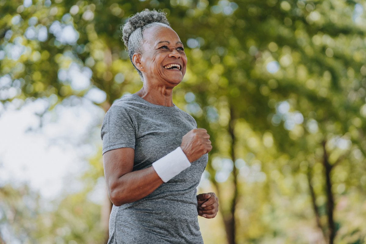 Woman walking in the park and smiling