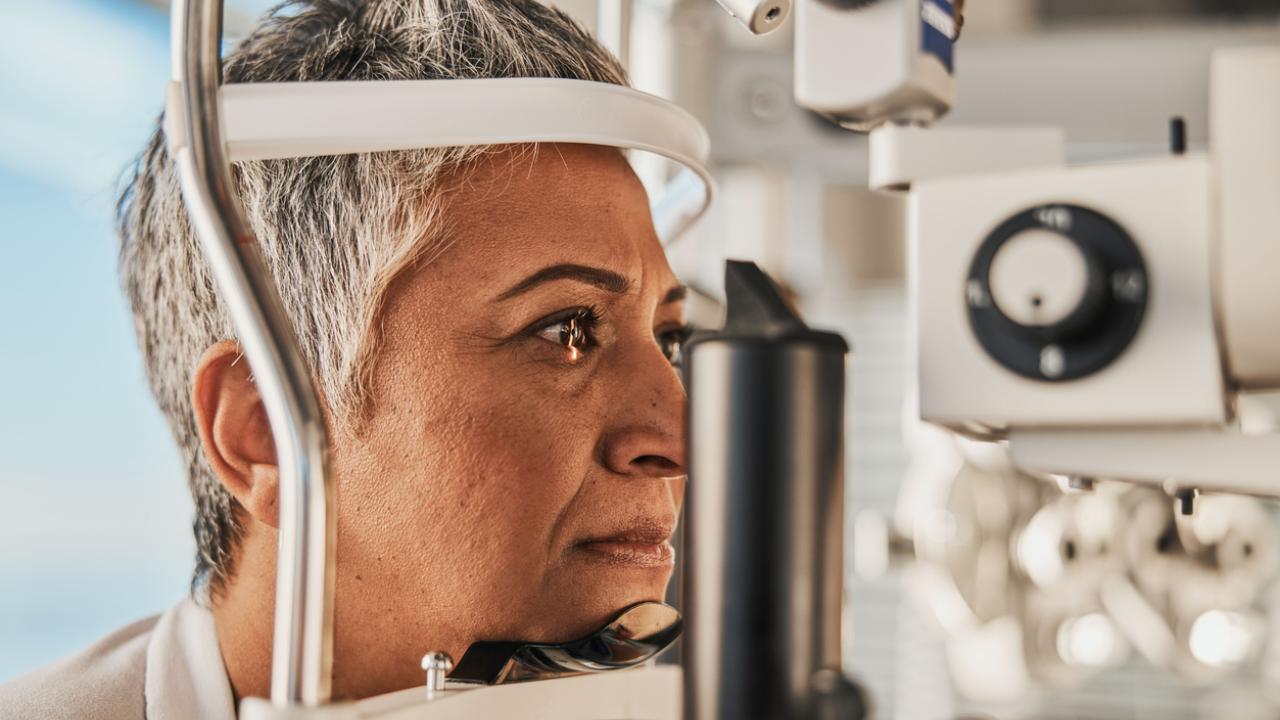 Woman undergoing an eye examination with advanced medical equipment.