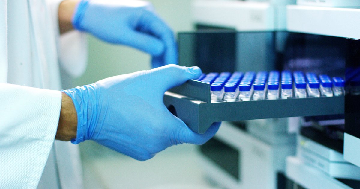 A researcher handles equipment in the lab.