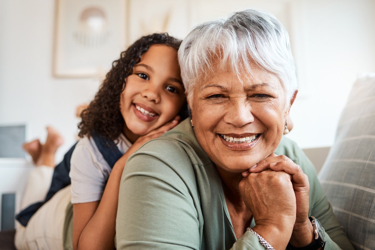 A grandmother smiles with her granddaughter