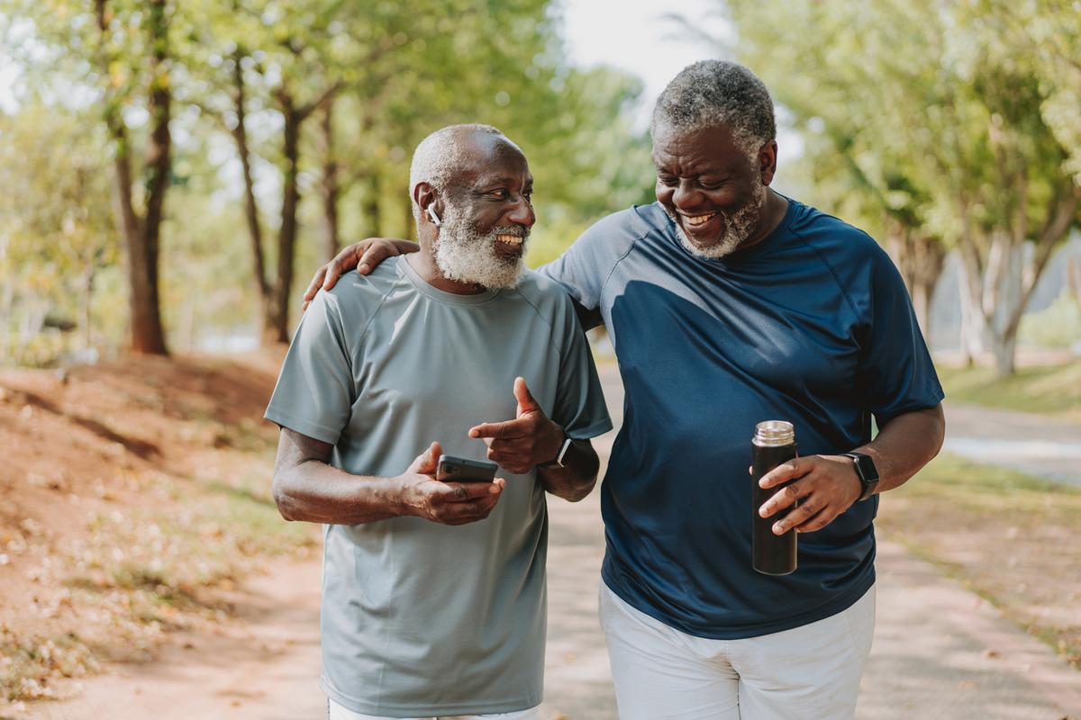 Two friends walking together in the park.