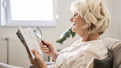 Woman reading with a magnifier